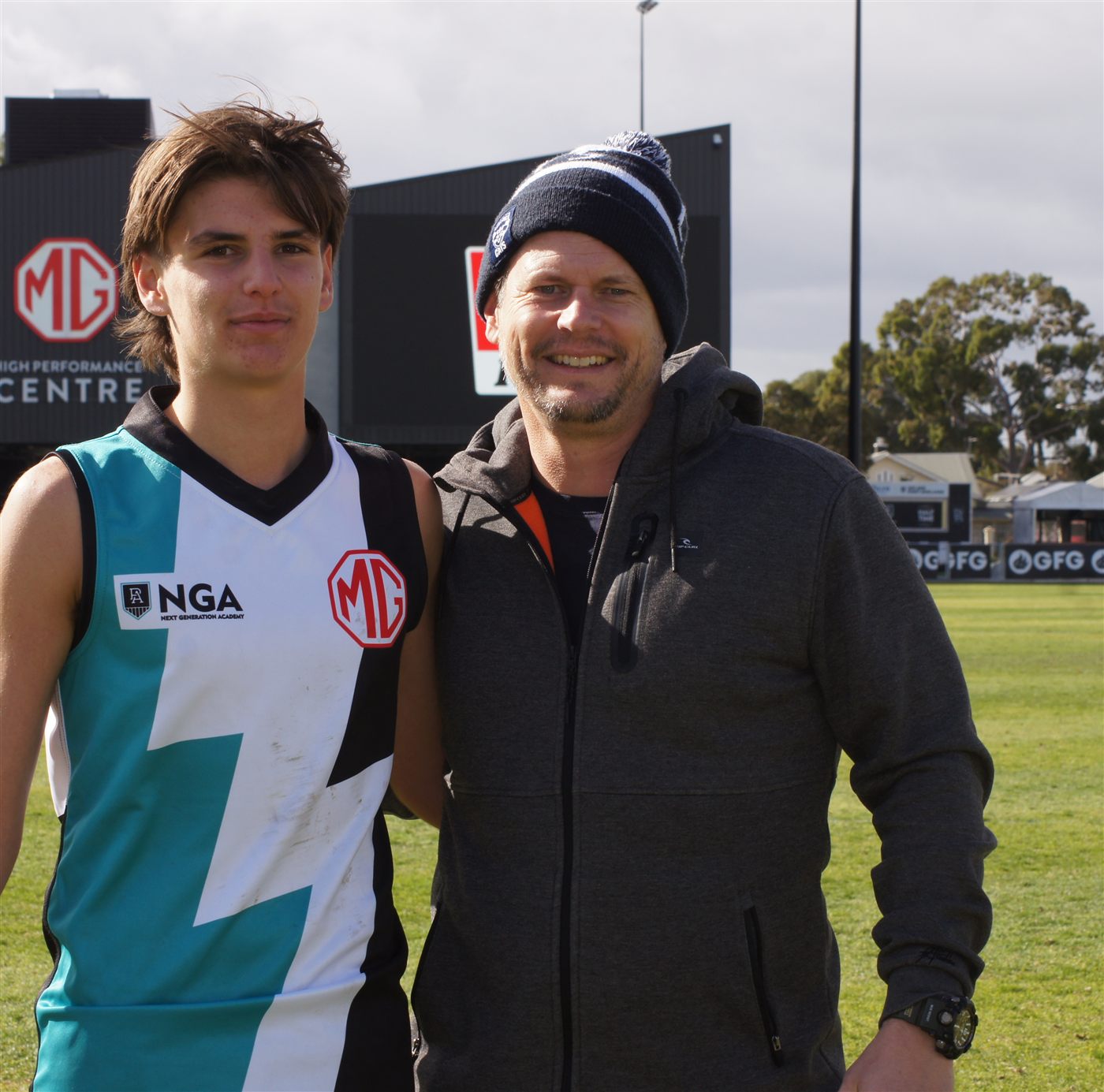 Glen Laundy with his son at the local football oval